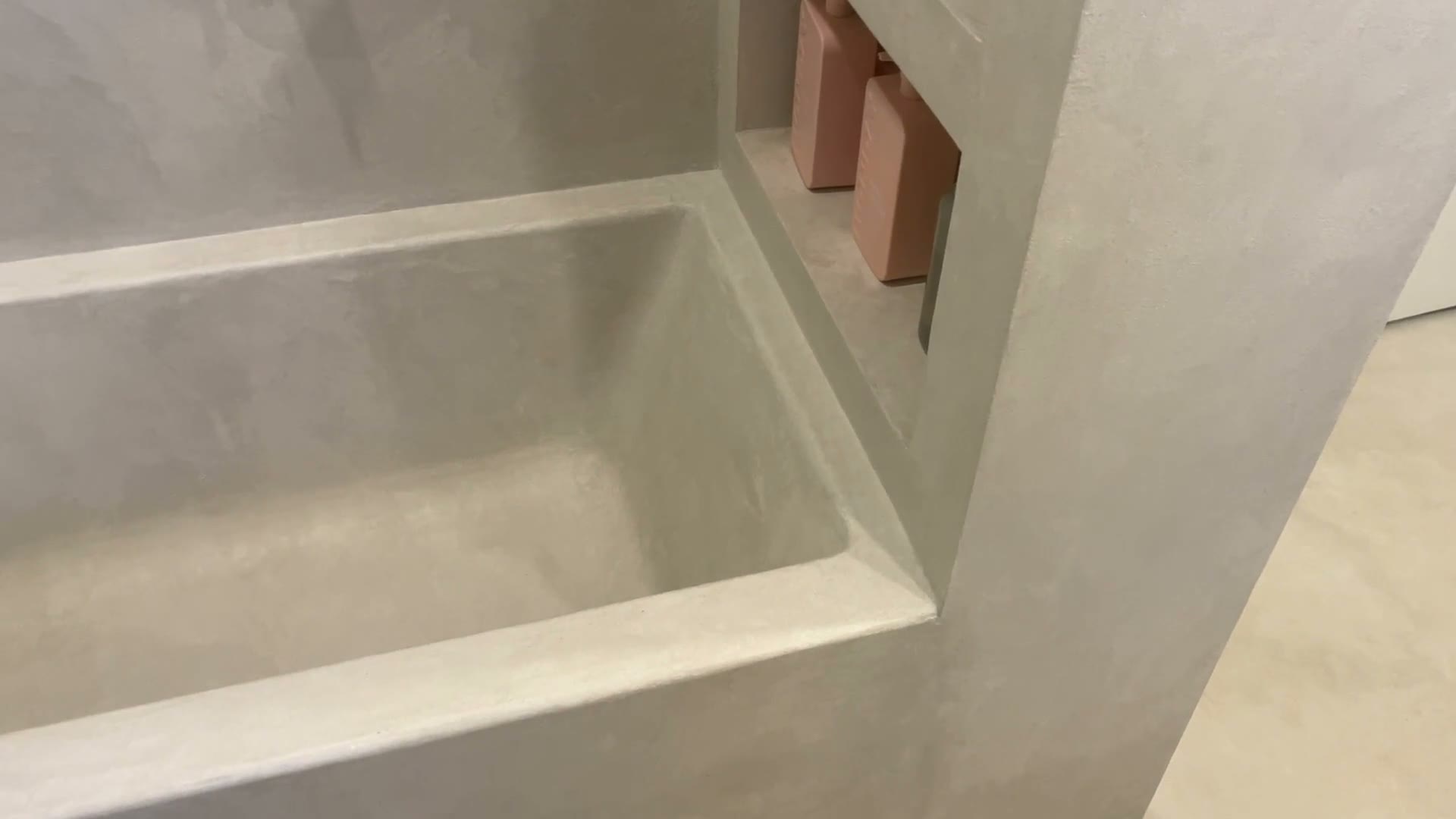 Seamless warm microcement interior in an Edmonton studio